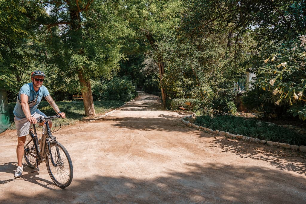 Blogger Robin cycling in Athens through the city gardens.