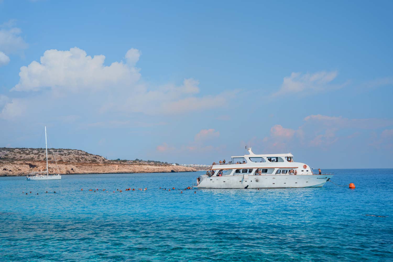 Boat with tourists at Blue Lagoon in Cyprus.