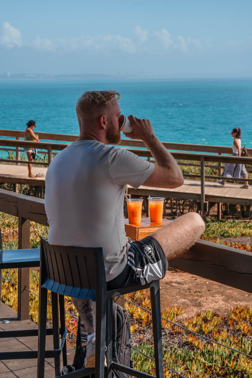 Blogger Robin drinking orange juice during Ponta da Piedade Hike, which is a must do on any Algarve itinerary!